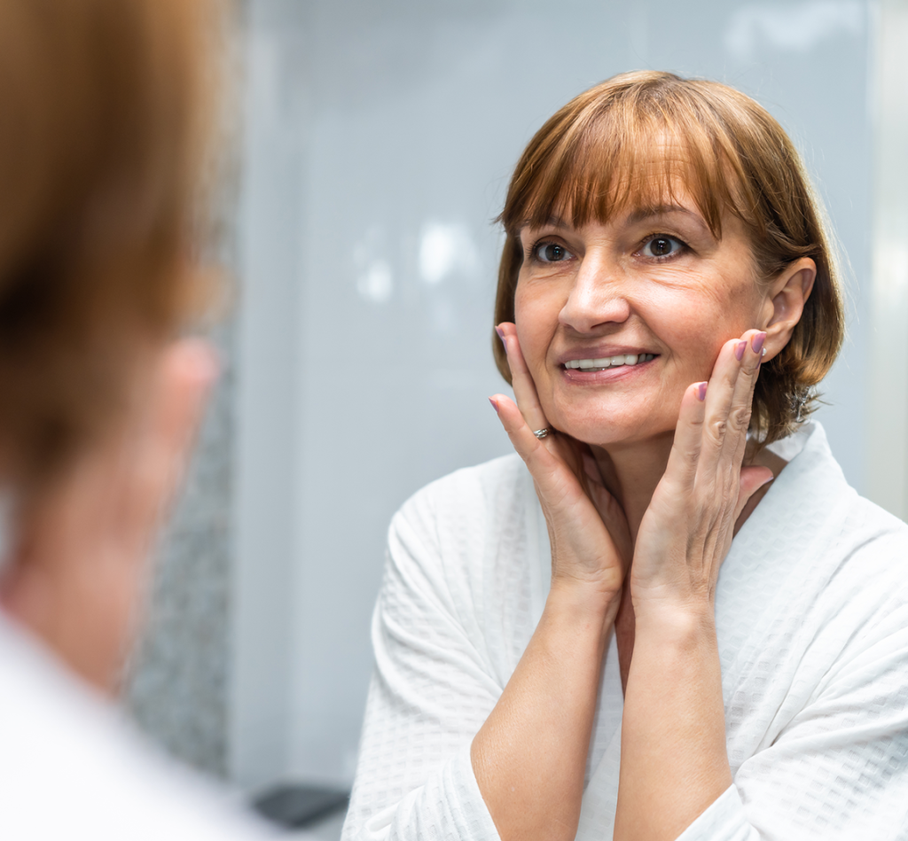 older woman looking in mirrow